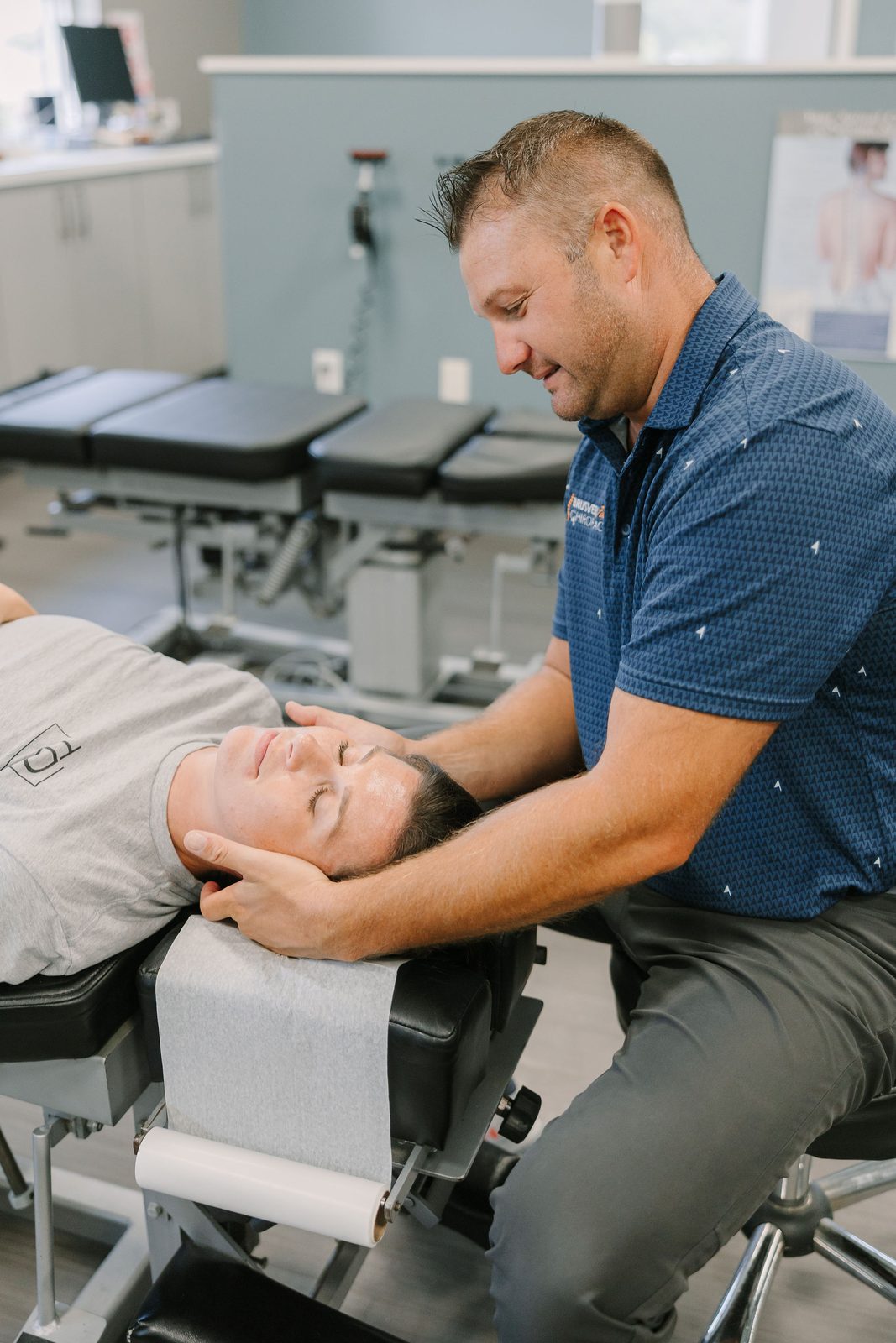 Chiropractor performing a cervical adjustment in Allendale, MI